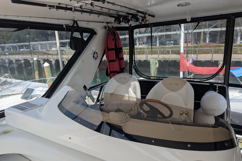Slide: The Image of Interior view of 1998 Sea Ray 480 Sedan Bridge yacht with helm and fishing rods. - 20
