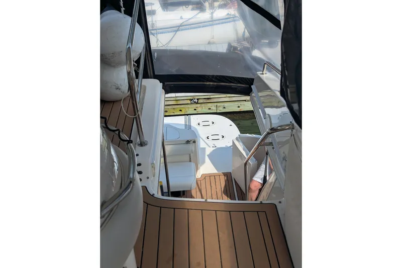 Slide: The Image of 1998 Sea Ray 480 Sedan Bridge yacht interior with teak flooring and seating area. - 21