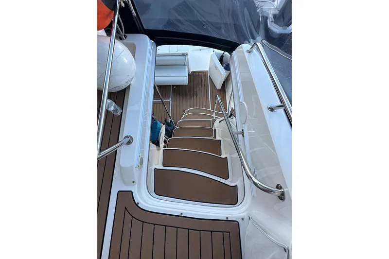 Slide: The Image of Staircase on 1998 Sea Ray 480 Sedan Bridge yacht with teak flooring and stainless steel railings. - 22