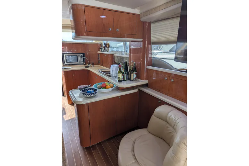 Slide: The Image of Luxurious 1998 Sea Ray 480 Sedan Bridge yacht interior with modern kitchen and seating. - 25