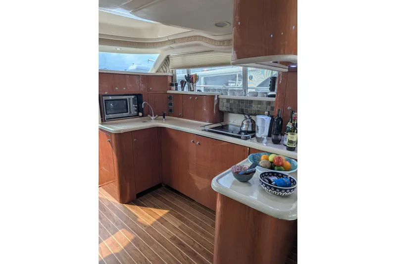 Slide: The Image of Luxurious kitchen interior of 1998 Sea Ray 480 Sedan Bridge yacht. - 26