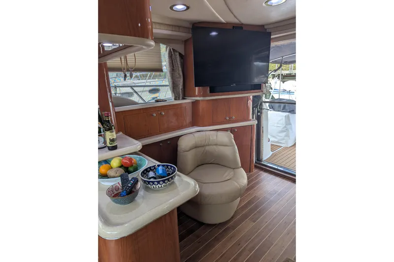 Slide: The Image of Luxurious interior of 1998 Sea Ray 480 Sedan Bridge with leather chair and flat-screen TV. - 27