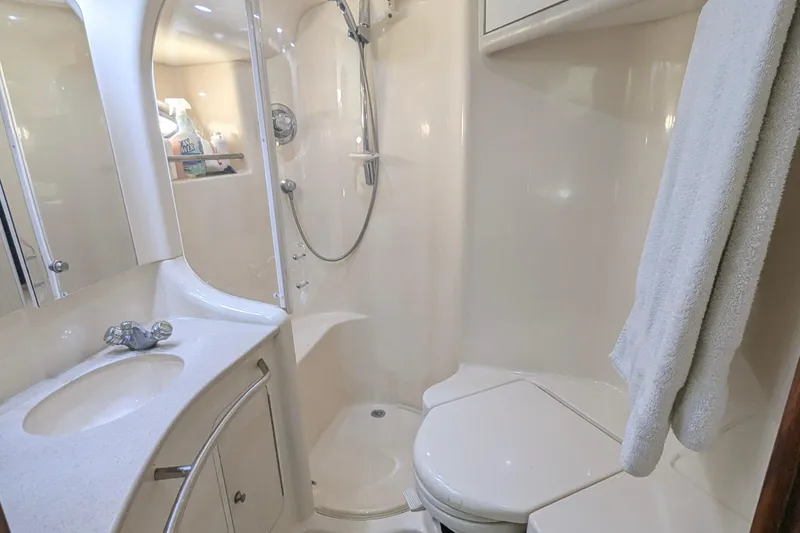 Slide: The Image of 1998 Sea Ray 480 Sedan Bridge bathroom with shower, sink, and towel. - 30