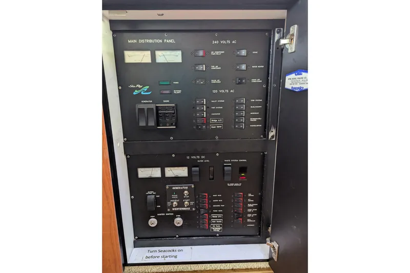 Slide: The Image of Main distribution panel of 1998 Sea Ray 480 Sedan Bridge yacht, showing electrical controls. - 36