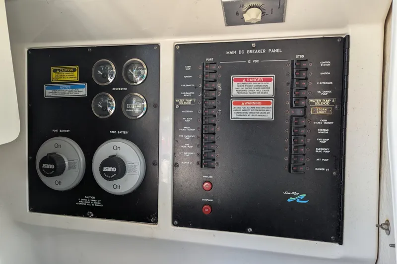 Slide: The Image of Main DC breaker panel of 1998 Sea Ray 480 Sedan Bridge with battery controls and gauges. - 37