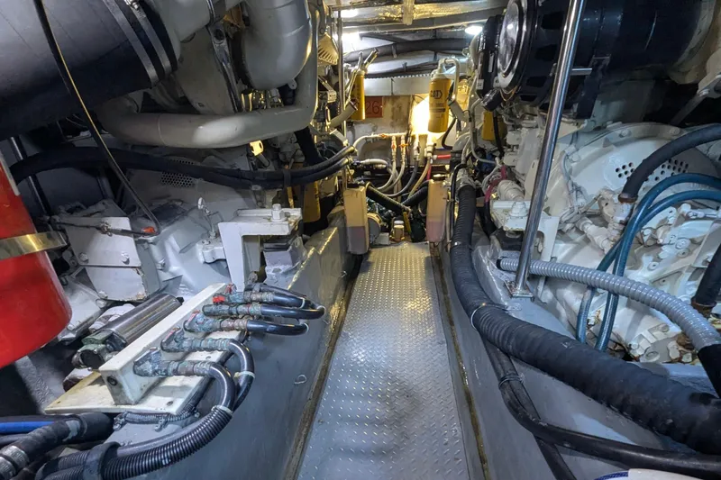 Slide: The Image of Engine room of a 1998 Sea Ray 480 Sedan Bridge yacht, showcasing mechanical components. - 39