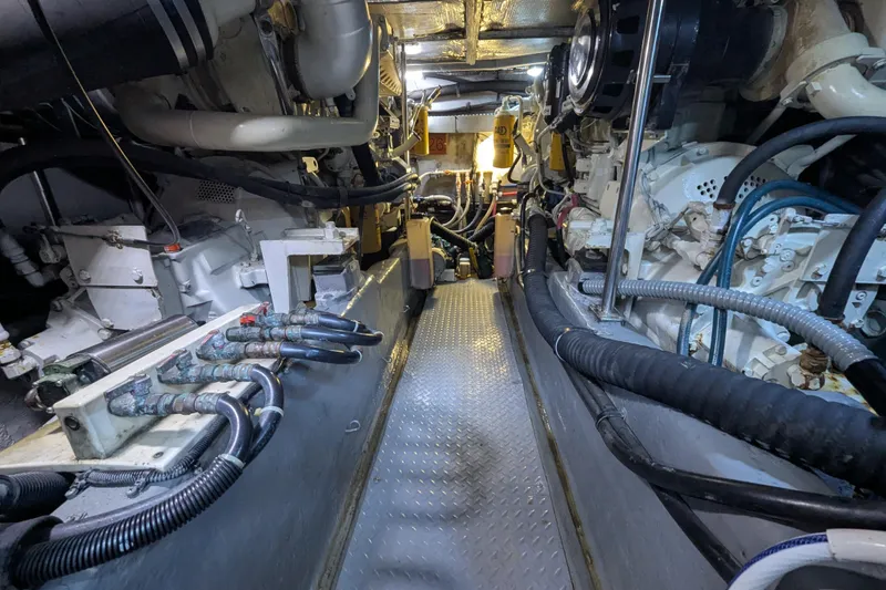 Slide: The Image of Engine room of a 1998 Sea Ray 480 Sedan Bridge, showcasing mechanical components and piping. - 40