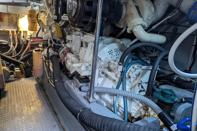 Slide: The Image of Engine room of a 1998 Sea Ray 480 Sedan Bridge with visible machinery and cables. - 43