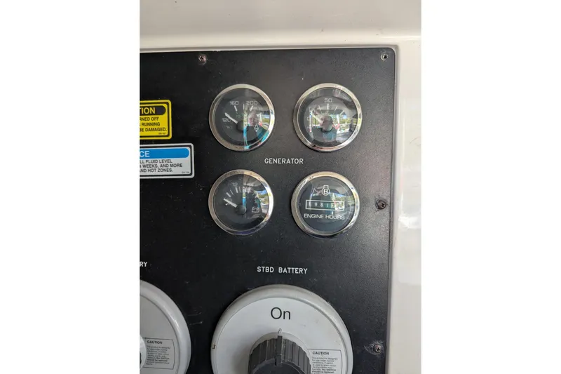 Slide: The Image of Control panel of a 1998 Sea Ray 480 Sedan Bridge with gauges and switches. - 44