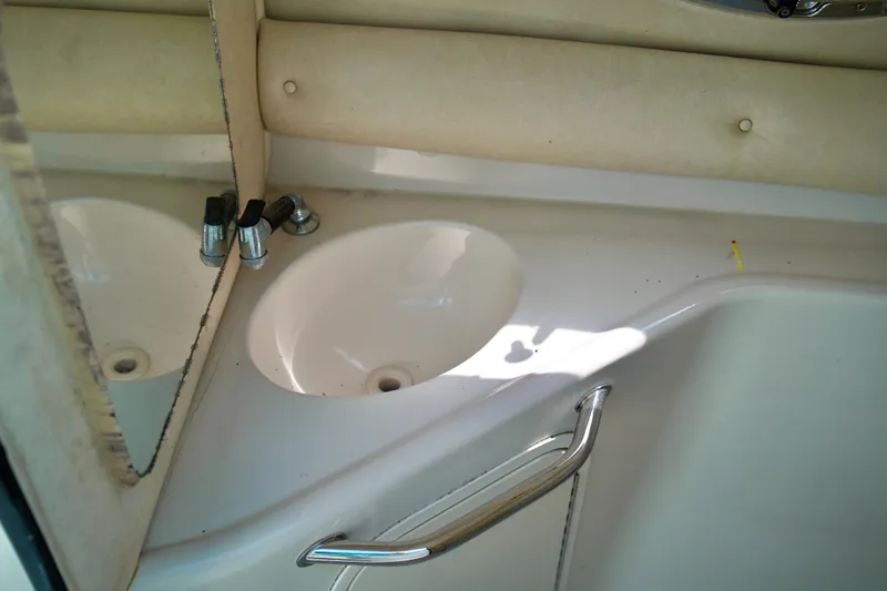 Slide: The Image of 2005 Sea Ray 240 Bow Rider boat interior sink with mirror and faucet. - 14