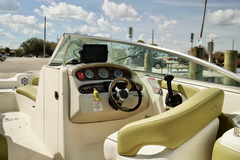 Slide: The Image of 2005 Sea Ray 240 Bow Rider boat interior with steering wheel and dashboard controls. - 7