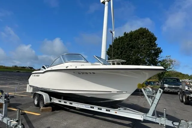 Slide: The Image of 2019 Key West 239 DFS boat on trailer in parking lot, clear sky background. - 14