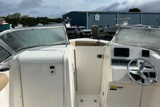 Slide: The Image of 2019 Key West 239 DFS boat interior with steering wheel and dashboard controls. - 15