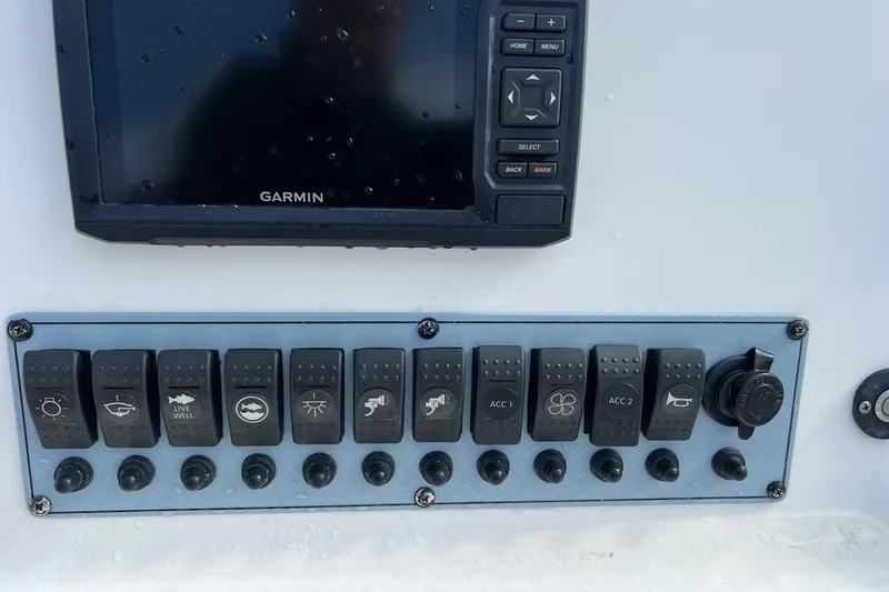 Slide: The Image of Control panel of a 2019 Key West 239 DFS boat with Garmin display and switches. - 16