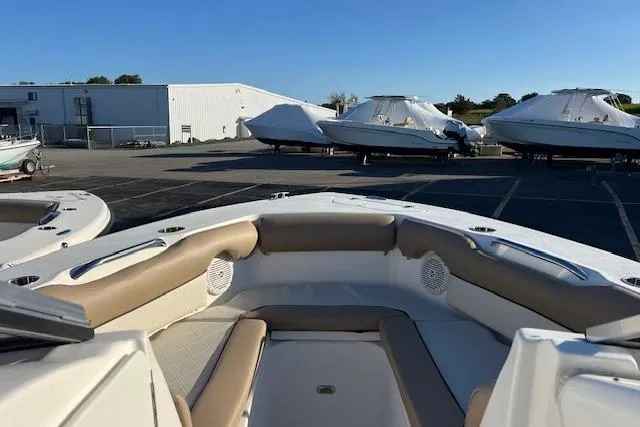 Slide: The Image of 2019 Key West 239 DFS boat interior with tan seating, parked near covered boats. - 7