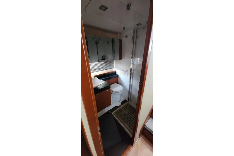 Slide: The Image of Bathroom interior of 2016 Jeanneau Prestige 50 yacht, featuring modern fixtures and wooden cabinetry. - 19