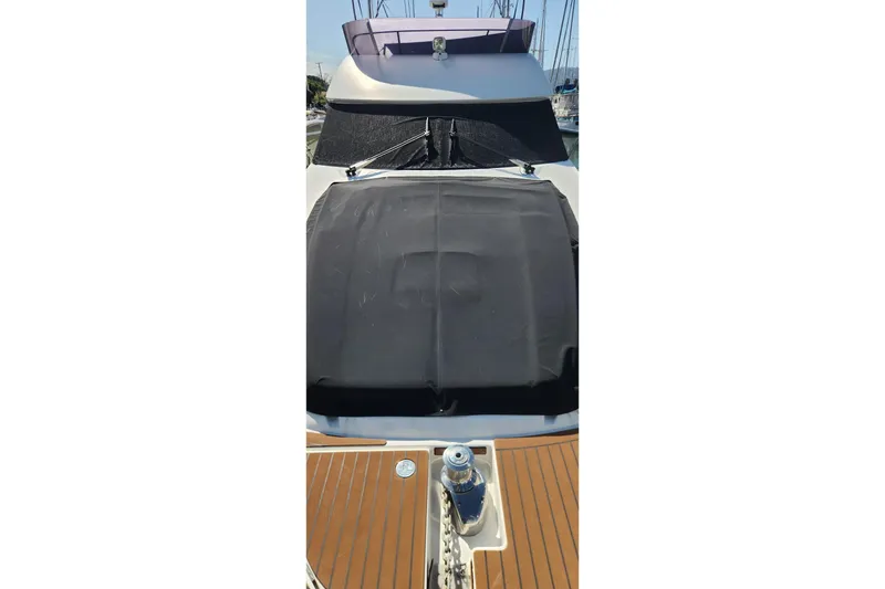 Slide: The Image of 2016 Jeanneau Prestige 50 yacht with covered deck and winch, docked at marina. - 24