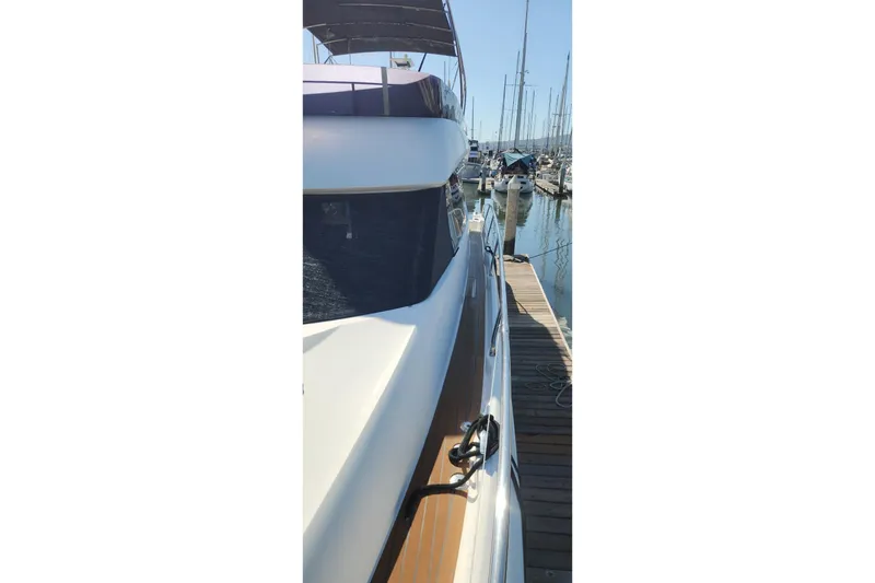 Slide: The Image of 2016 Jeanneau Prestige 50 yacht docked at marina, side view. - 25
