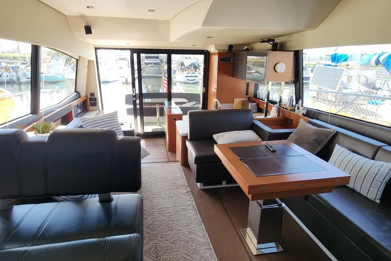 Slide: The Image of Luxurious interior of a 2016 Jeanneau Prestige 50 yacht, featuring elegant seating and modern decor. - 5