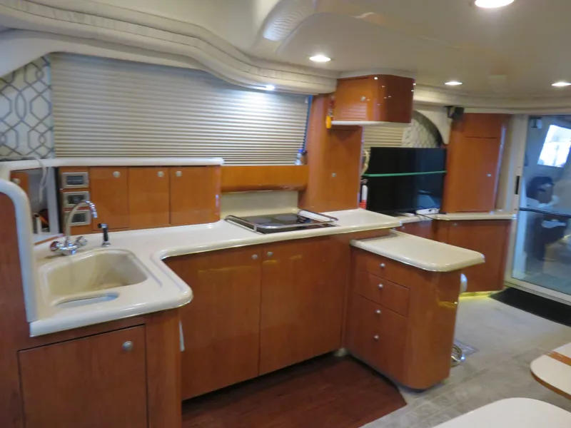 Slide: The Image of 1999 Sea Ray 480 DB yacht interior with modern kitchen. - 14