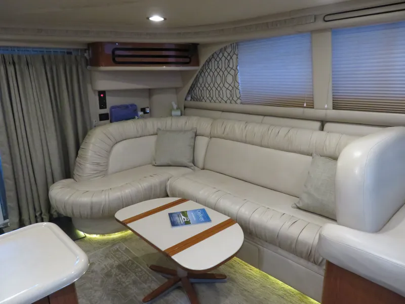 Slide: The Image of Interior of a 1999 Sea Ray 480 DB yacht with beige sofa. - 15