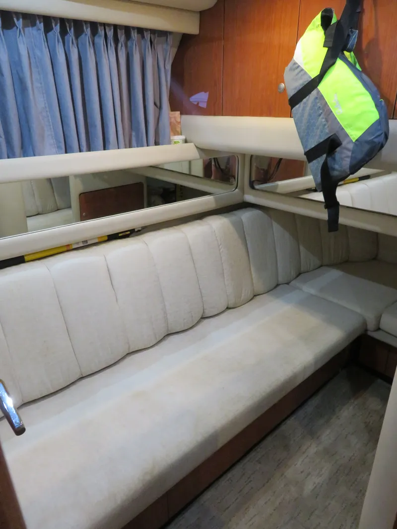 Slide: The Image of Interior of 1999 Sea Ray 480 DB yacht with sofa and life jacket. - 17