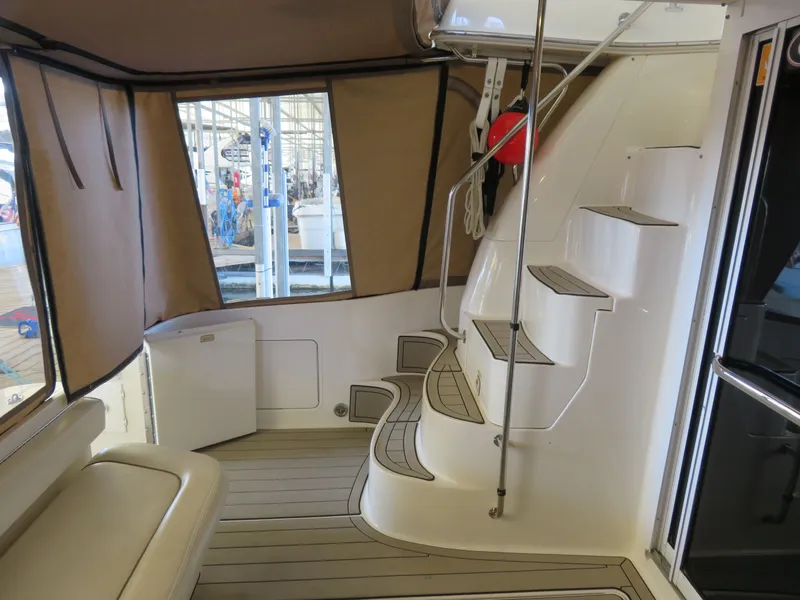 Slide: The Image of Interior of a 1999 Sea Ray 480 DB yacht with stairs and seating area. - 7