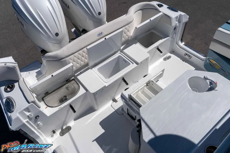 Slide: The Image of 2026 Sea Hunt Ultra 275 SE boat interior with storage compartments and dual Yamaha engines. - 13