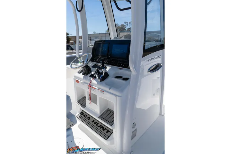 Slide: The Image of 2026 Sea Hunt Ultra 275 SE boat console with steering wheel and controls. - 17