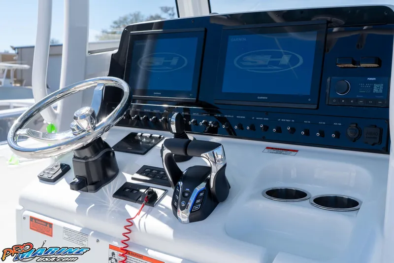 Slide: The Image of Control panel of 2026 Sea Hunt Ultra 275 SE boat with steering wheel and digital displays. - 18