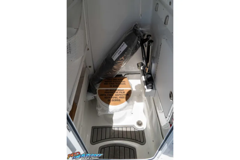 Slide: The Image of Interior of 2026 Sea Hunt Ultra 275 SE boat, featuring storage compartment and equipment. - 27
