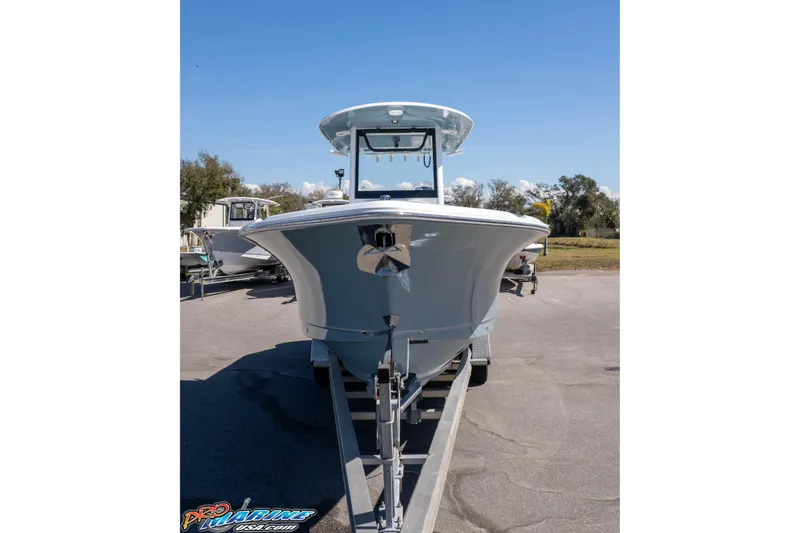 Slide: The Image of 2026 Sea Hunt Ultra 275 SE boat on trailer, front view under clear blue sky. - 29