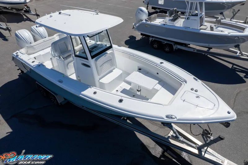 Slide: The Image of 2026 Sea Hunt Ultra 275 SE boat on trailer, featuring dual engines and spacious deck. - 3