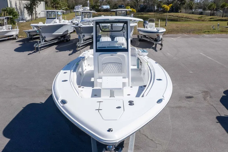 Slide: The Image of 2026 Sea Hunt Ultra 275 SE boat displayed in a parking lot with other boats. - 30