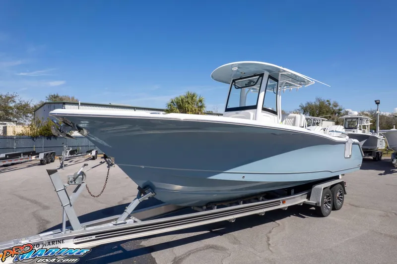 Slide: The Image of 2026 Sea Hunt Ultra 275 SE boat on trailer, displayed outdoors under clear blue sky. - 32