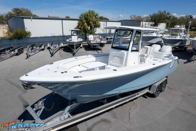 Slide: The Image of 2026 Sea Hunt Ultra 275 SE boat on trailer in marina setting. - 33