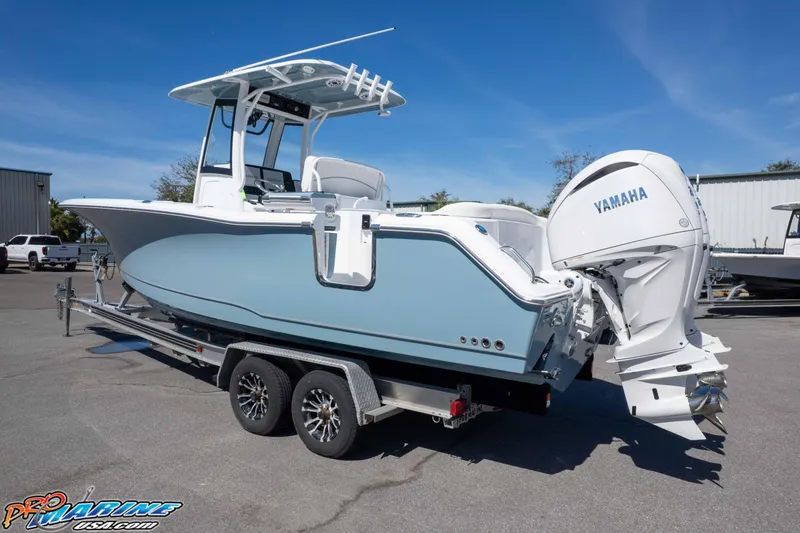 Slide: The Image of 2026 Sea Hunt Ultra 275 SE boat on trailer with Yamaha engine, parked outdoors. - 38
