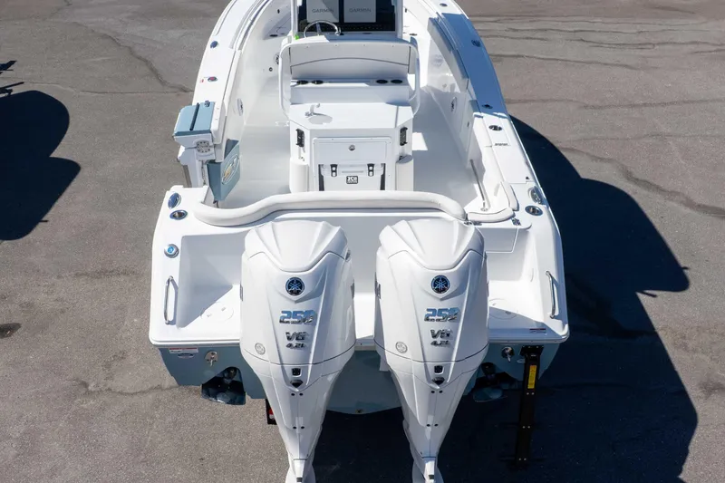 Slide: The Image of 2026 Sea Hunt Ultra 275 SE boat with dual Yamaha outboard engines, viewed from the rear. - 43