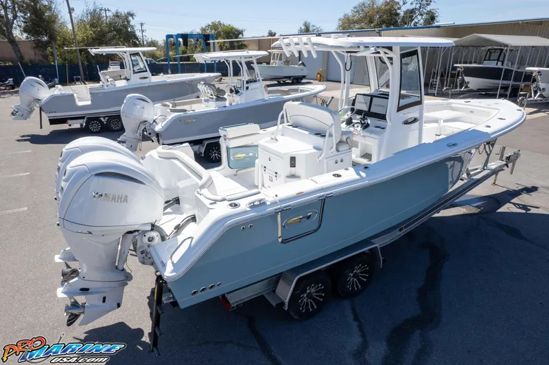 Slide: The Image of 2026 Sea Hunt Ultra 275 SE boat with Yamaha engines in a marina setting. - 45