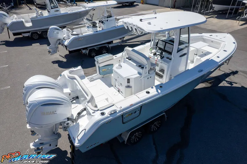 Slide: The Image of 2026 Sea Hunt Ultra 275 SE boat with dual Yamaha engines, docked in a marina. - 46