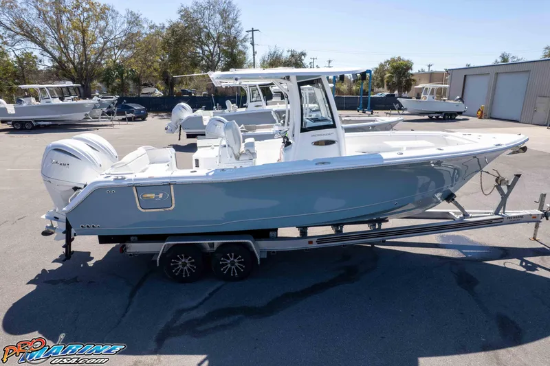 Slide: The Image of 2026 Sea Hunt Ultra 275 SE boat on trailer in marina setting. - 48