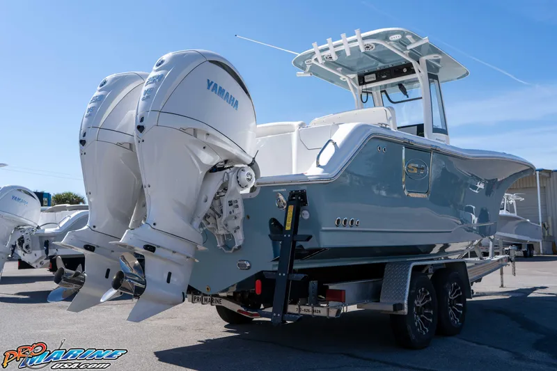 Slide: The Image of 2026 Sea Hunt Ultra 275 SE boat with dual Yamaha engines on a trailer. - 6