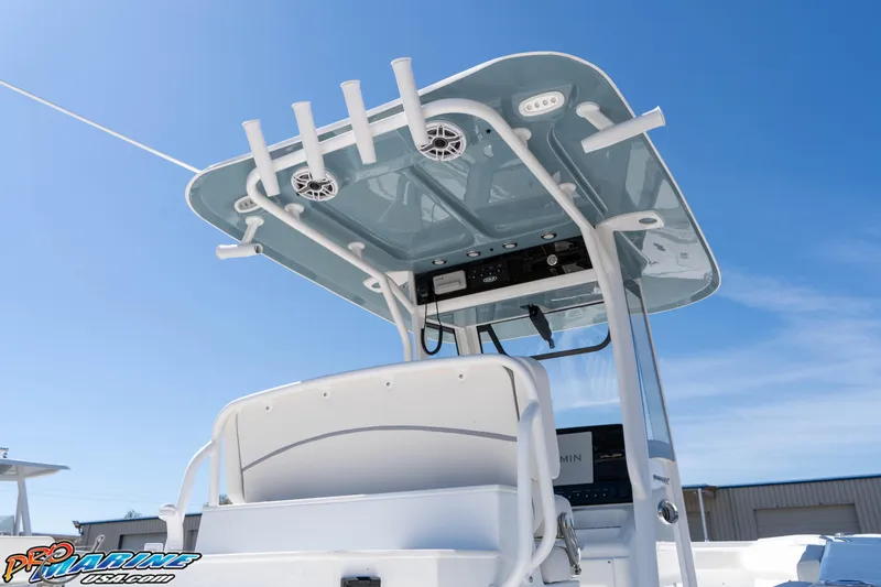 Slide: The Image of 2026 Sea Hunt Ultra 275 SE boat with T-top and rod holders under clear blue sky. - 8