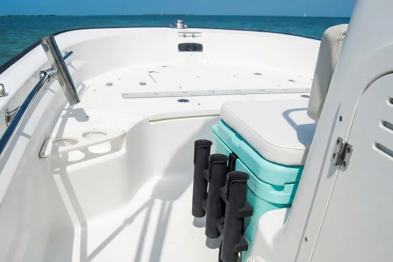 Slide: The Image of 2020 Boston Whaler 190 Montauk boat on clear blue water, featuring a black canopy. - 10