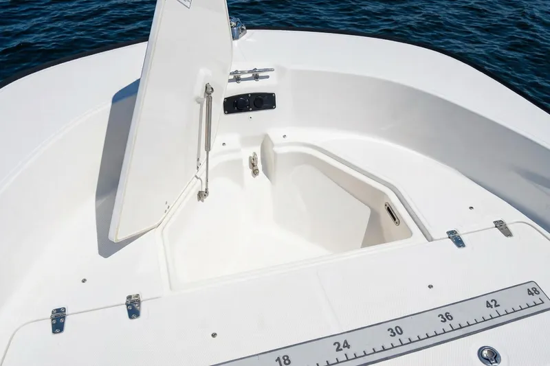 Slide: The Image of 2020 Boston Whaler 190 Montauk boat interior with seating and rod holders. - 13