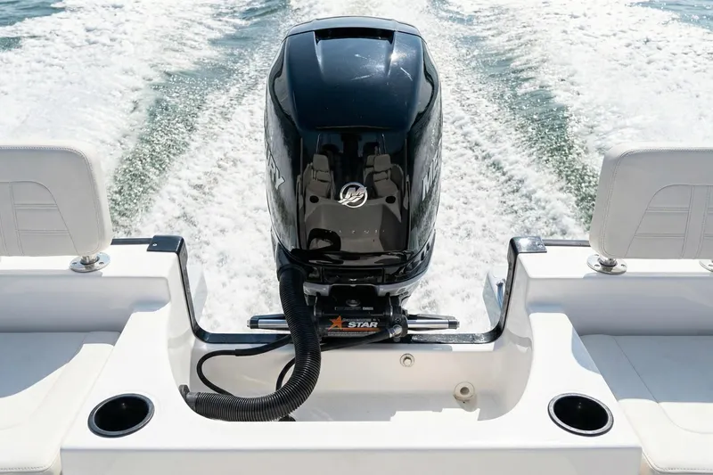 Slide: The Image of 2020 Boston Whaler 190 Montauk boat seat with cup holder, cruising on water. - 19