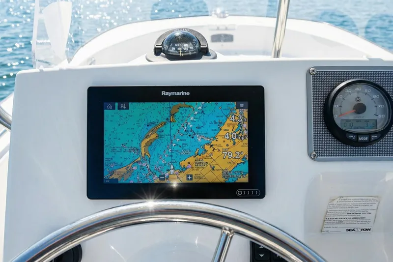 Slide: The Image of 2020 Boston Whaler 190 Montauk boat side view with clear branding. - 4