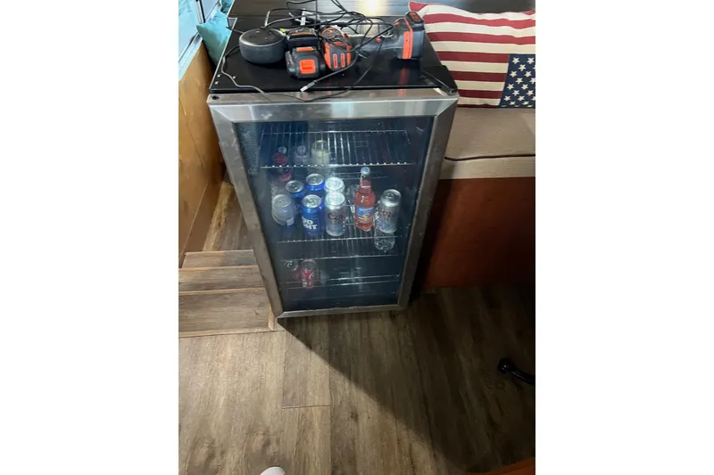 Slide: The Image of Mini fridge stocked with drinks inside a 1989 Holiday Mansion Super boat. - 10