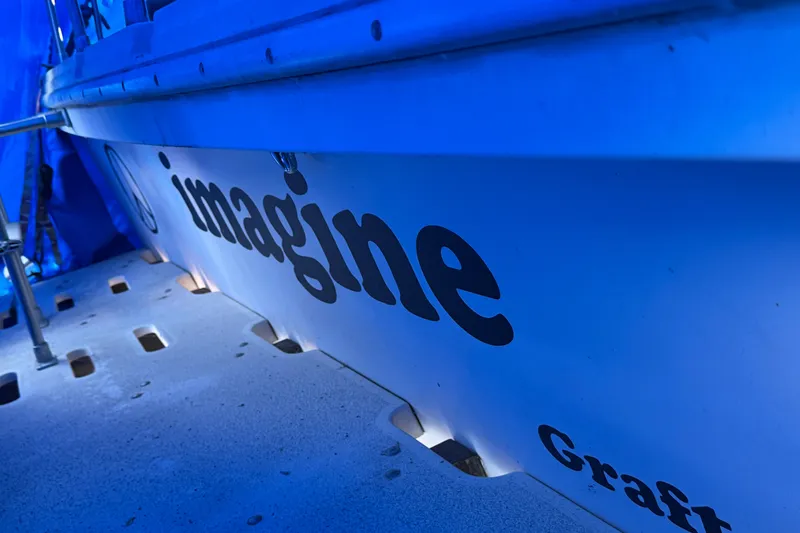 Slide: The Image of 1989 Holiday Mansion Super boat with "imagine" text, blue lighting. - 12