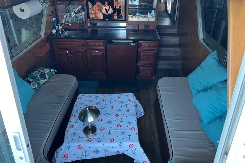 Slide: The Image of Interior of a 1989 Holiday Mansion Super houseboat with cozy seating and nautical decor. - 6